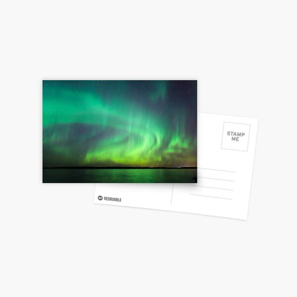 Northern lights over lake in Finland Postcard