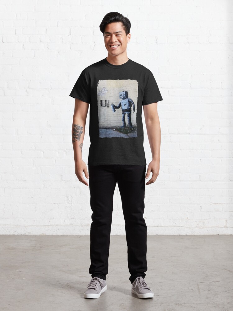 Alternate view of Banksy graffiti smiling Robot and barcodes Better Out Than In New York City residency on brick wall Classic T-Shirt
