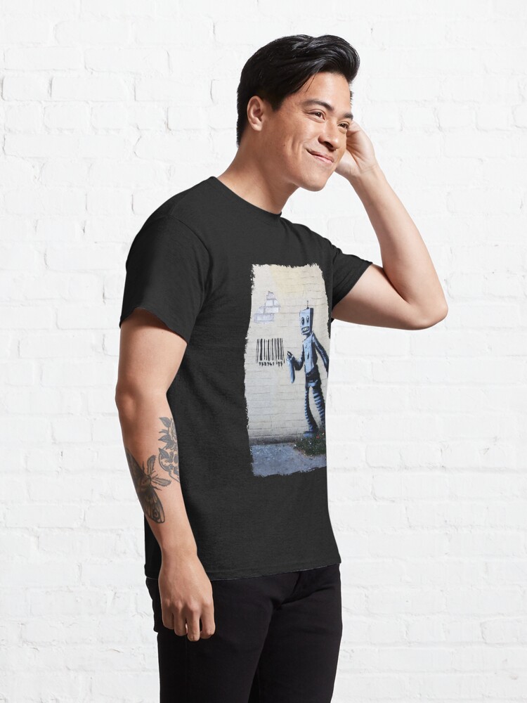 Alternate view of Banksy graffiti smiling Robot and barcodes Better Out Than In New York City residency on brick wall Classic T-Shirt