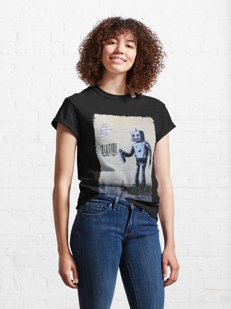 Alternate view of Banksy graffiti smiling Robot and barcodes Better Out Than In New York City residency on brick wall Classic T-Shirt