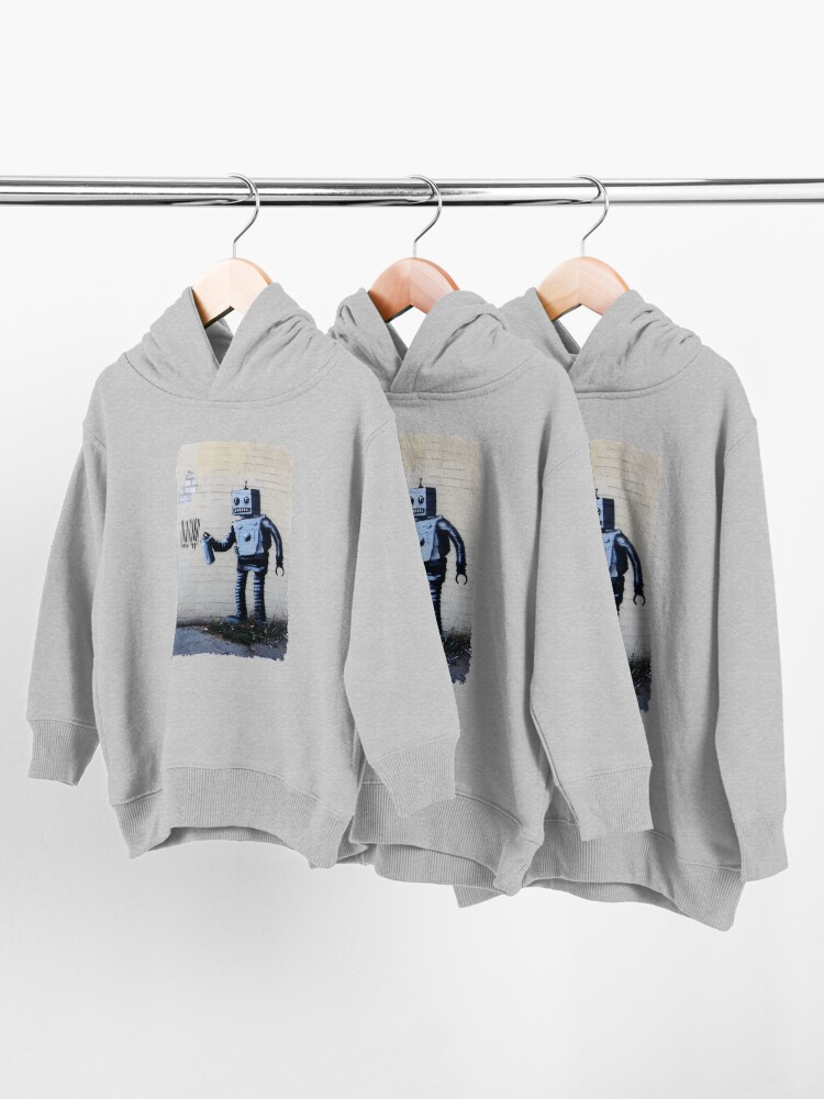 Alternate view of Banksy graffiti smiling Robot and barcodes Better Out Than In New York City residency on brick wall Toddler Pullover Hoodie
