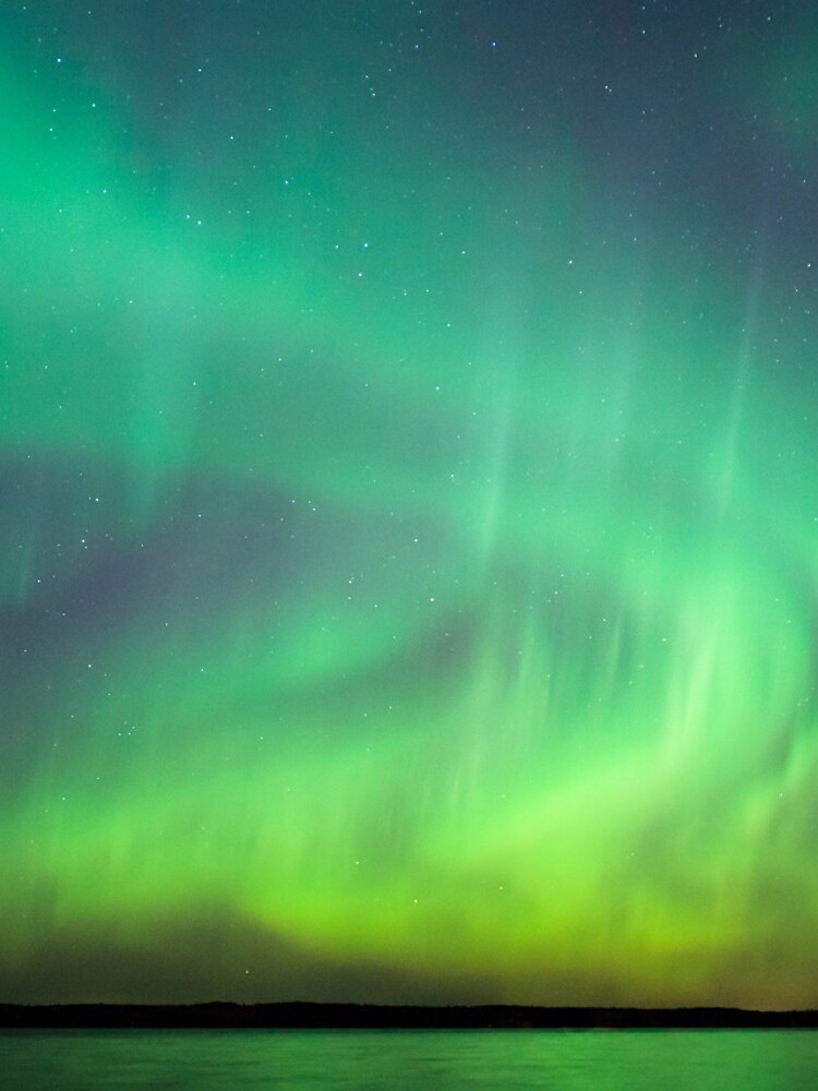 Northern lights over lake in Finland by Juhku