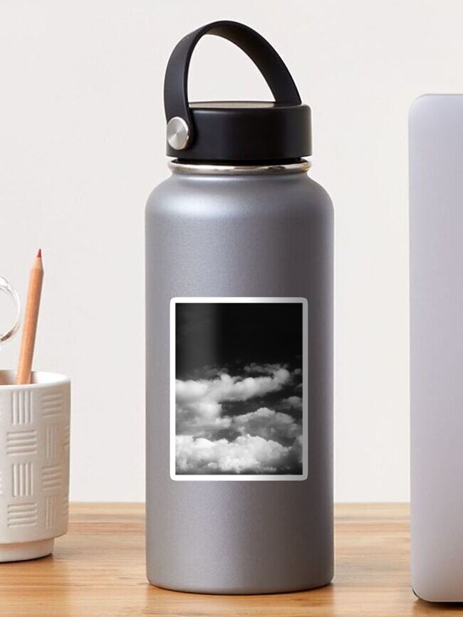Cute puffy small white clouds on a sunny aqua blue sky Water Bottle