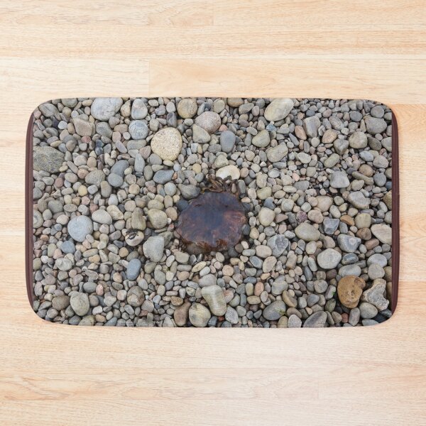 Jellyfish on a bed of pebbles Bath Mat