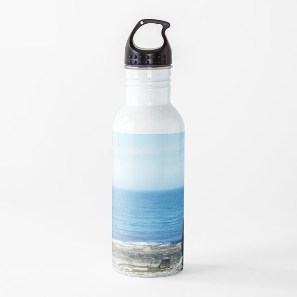 Rocks and raised ledge in sea Water Bottle