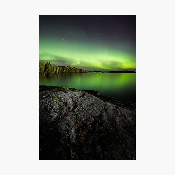 Northern lights glowing over lake in Finland Photographic Print