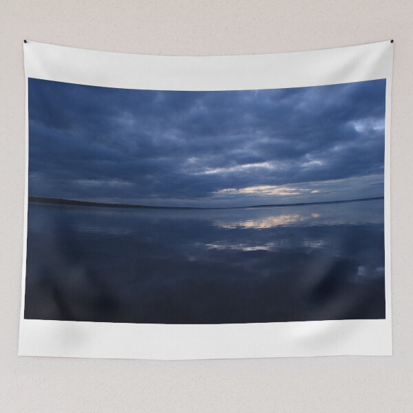Item preview, Cloudy blue sky in sunlight from dark clouds reflected on lake water designed and sold by yarvin13.