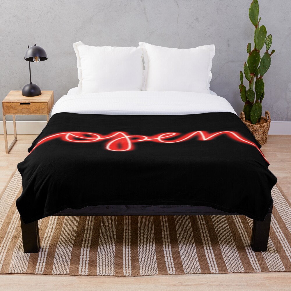 Open Red Neon Sign on a throw blanket