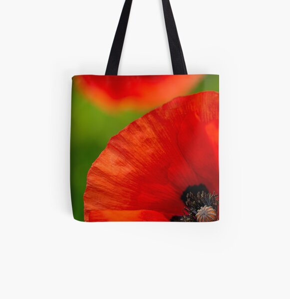 A close-up of a red field poppy All Over Print Tote Bag