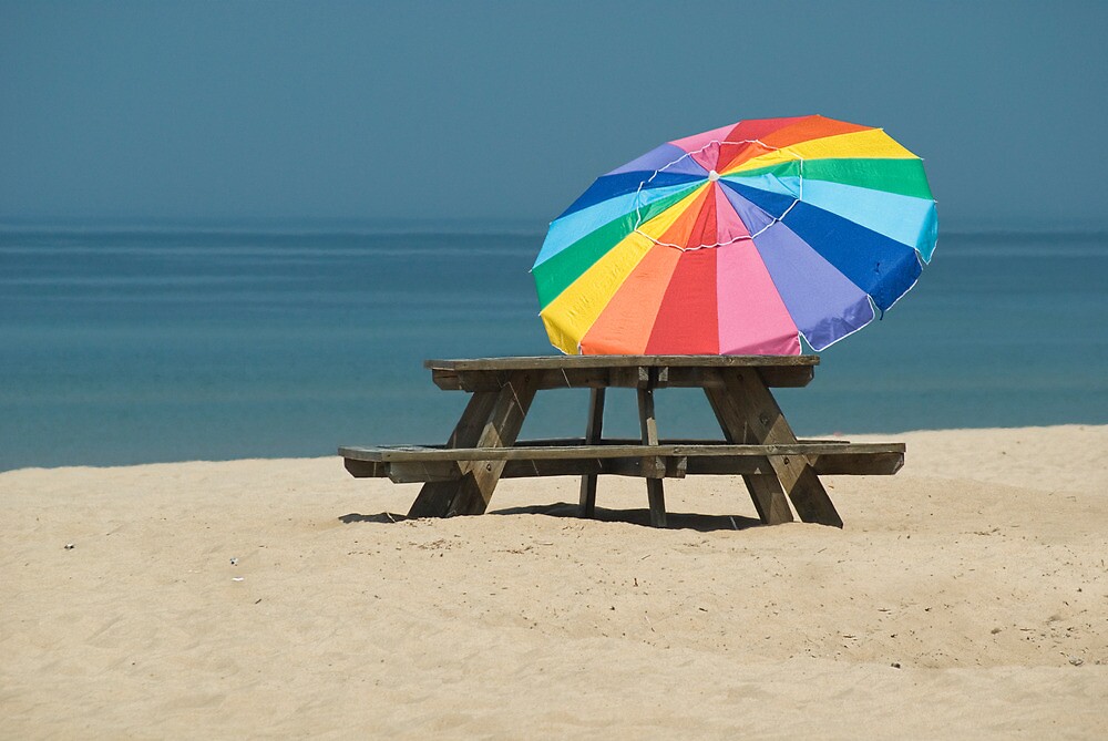 “Image of colorful beach umbrella and picnic table.” by Randall Nyhof