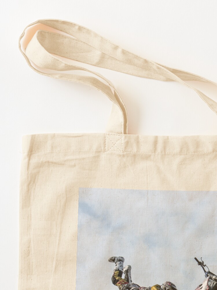 Alternate view of stuntman on a motor cycle jumps Tote Bag
