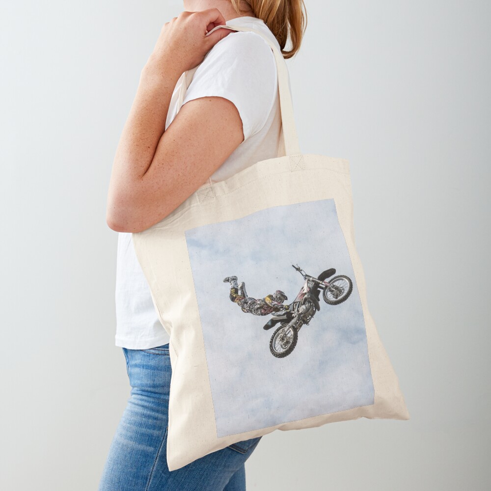 stuntman on a motor cycle jumps Tote Bag