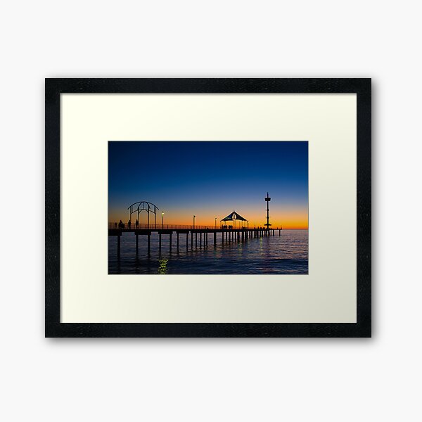 Beautiful Hues Spread Across The Horizon Providing The Perfect Backdrop For Adelaide's Historic Brighton Jetty Framed Art Print