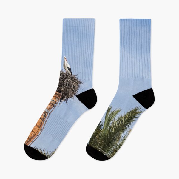 Item preview, Bringing Babies - White Storks Nesting on a Tall Brick Chimney Above the Treetops designed and sold by Georgia Mizuleva.