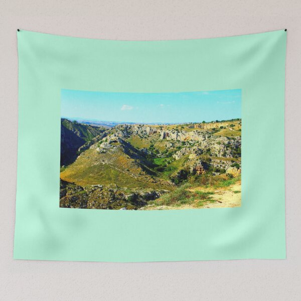 Item preview, Rocky canyon partly covered with green grass and randomly placed shrubs near Matera designed and sold by Kristina Drozd.