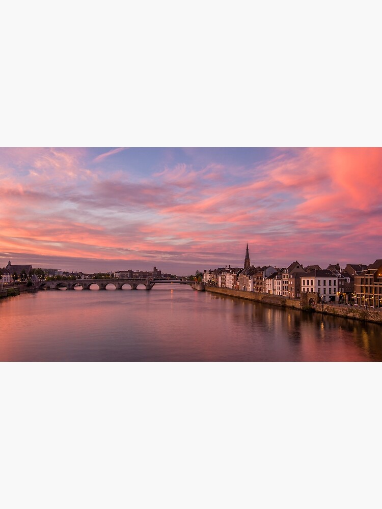 Colorful sunset over the river Maas in Maastricht, The Netherlands by bertbeckers